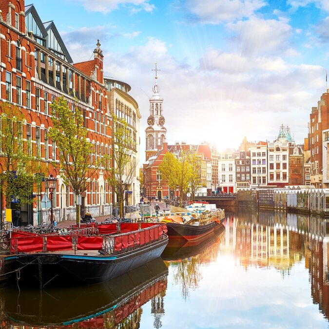 Kanal in Amsterdam Niederlande. Häuser und Fluss Amstel. Das berühmte europäische Wahrzeichen. Alte Stadtlandschaft bei Sonnenuntergang | © Shutterstock 2487675965